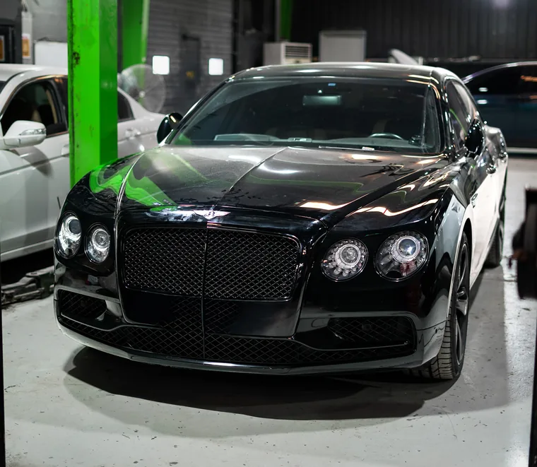 Bentley front end inspection on a lift at the Mussafah workshop