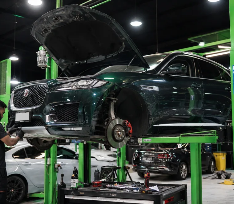 Jaguar F-Pace raised for undercarriage access at the Mussafah workshop